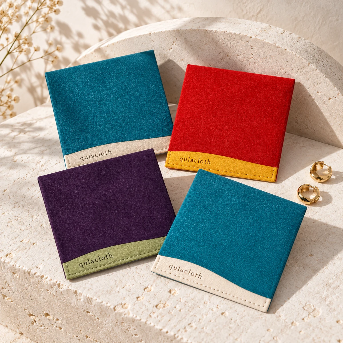 Custom 8 x 8 cm two-tone microfiber jewelry pouches in teal ivory purple sage red and mustard with Qulacloth logos
