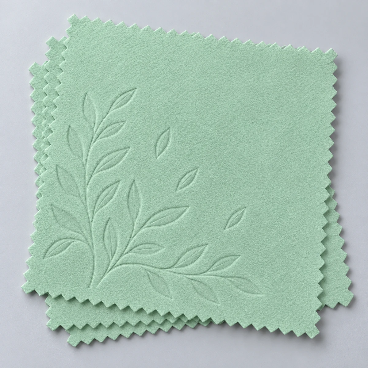 Mint green silver polishing cloths with an embossed leafy branch motif