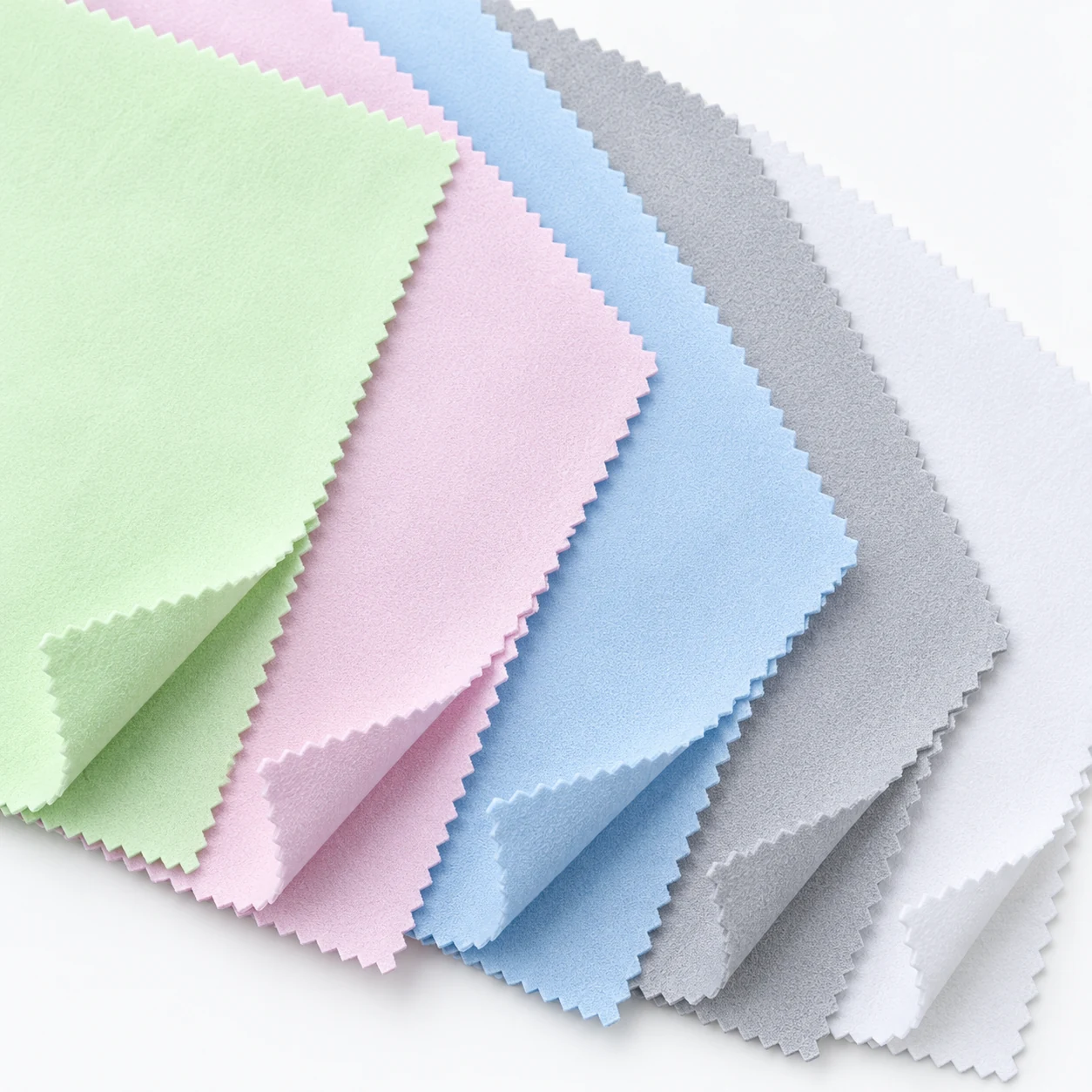 Close-up of soft double-sided flannel jewelry polishing cloth texture and zigzag edges in five colors