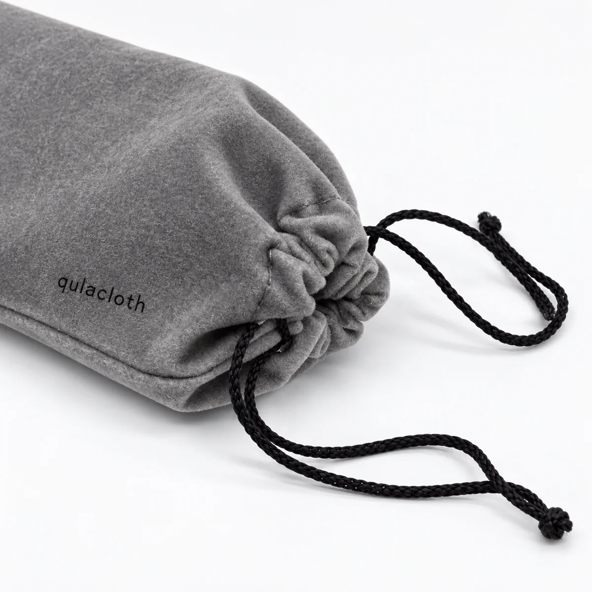 Close-up of gray flocked eyeglass pouch texture stitching and black drawstring closure