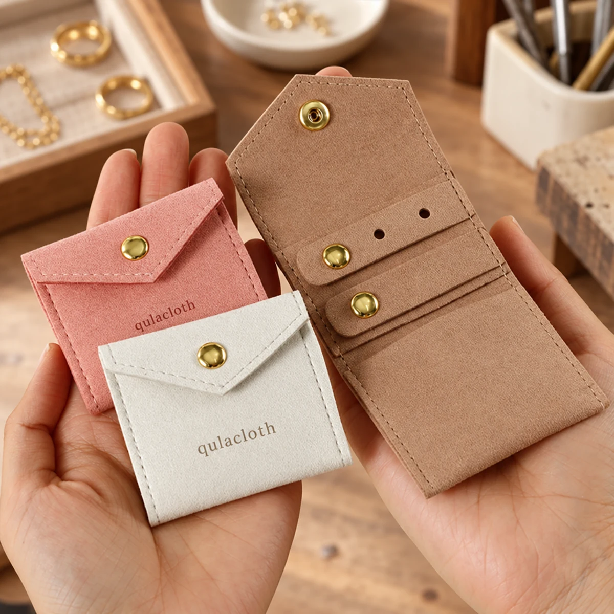 Handheld foldable microfiber jewelry pouches showing compact 6 x 5.5 cm size and internal organizer layout