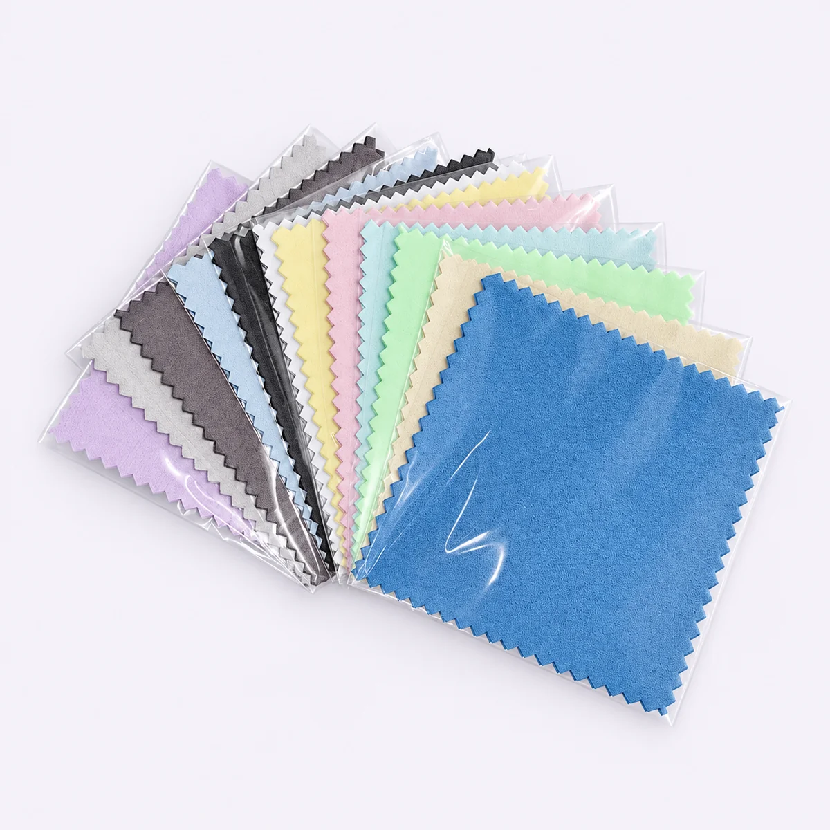 Blue individually packaged silver polishing cloth with assorted color options behind