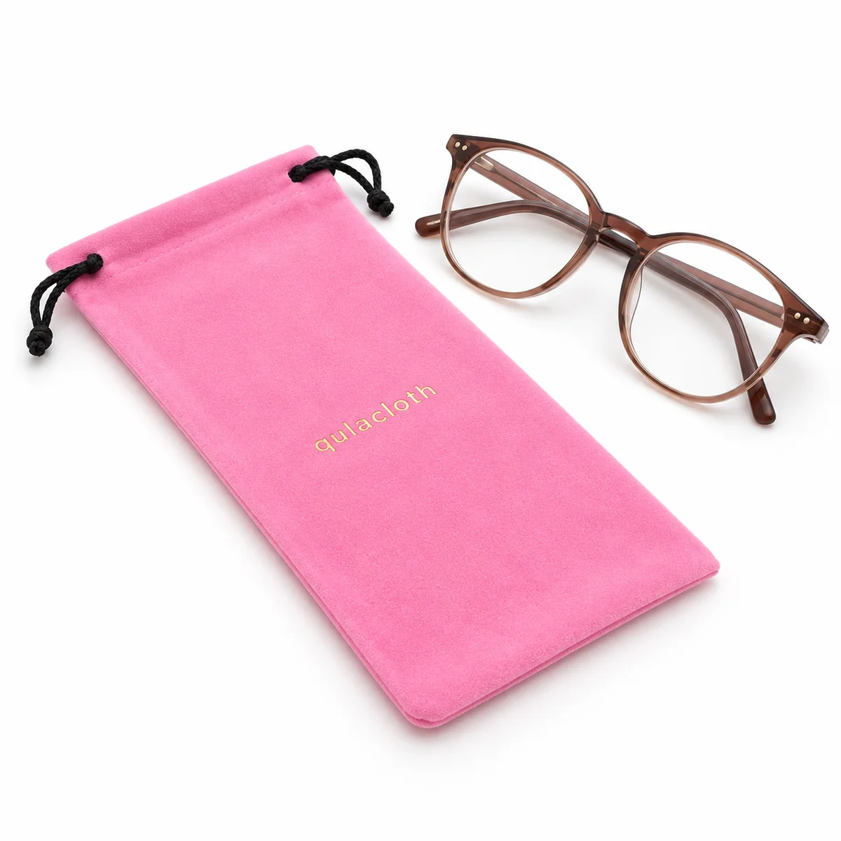 Pink flocked velvet eyeglass pouch with custom gold logo beside prescription glasses