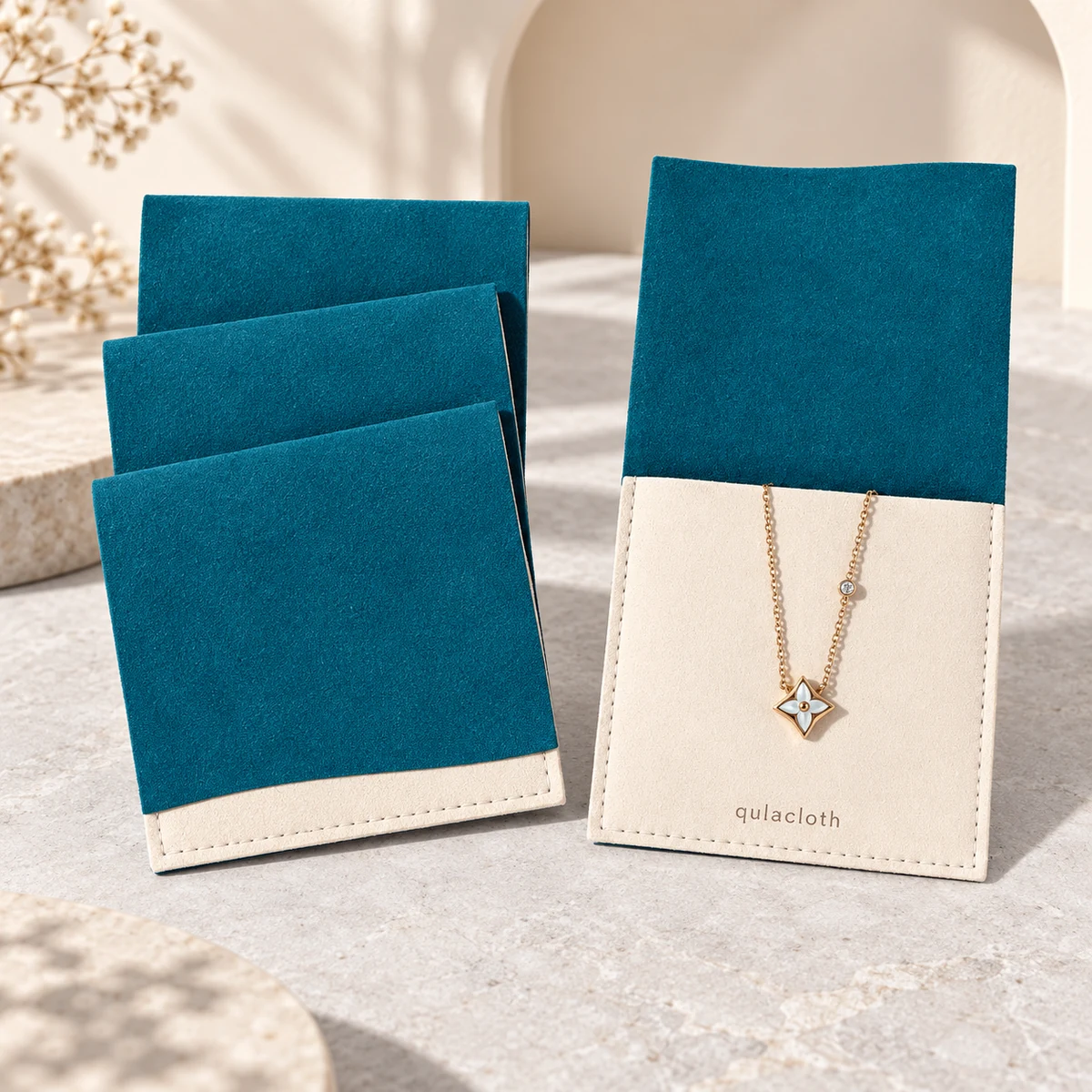 Teal and ivory microfiber necklace envelope pouch shown closed and open with stitched jewelry pocket