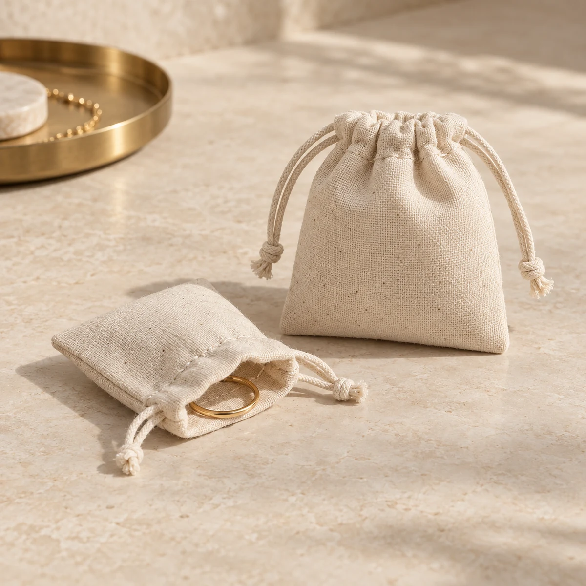 Natural unbleached cotton jewelry pouches in 6 x 6 cm and 8 x 8 cm with drawstring closures