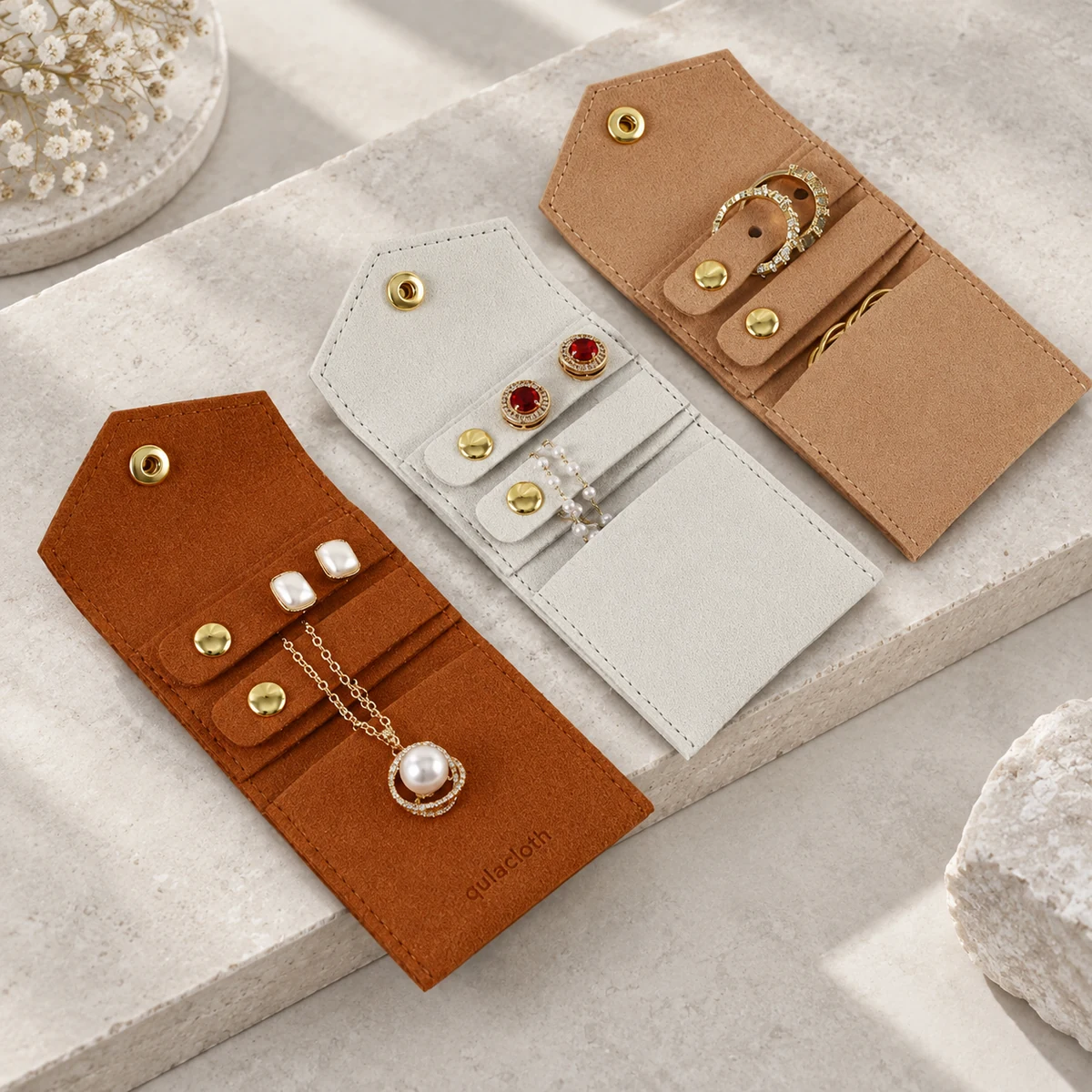 Unfolded 6 x 13.5 cm microfiber jewelry organizer pouches showing internal straps for earrings and necklaces