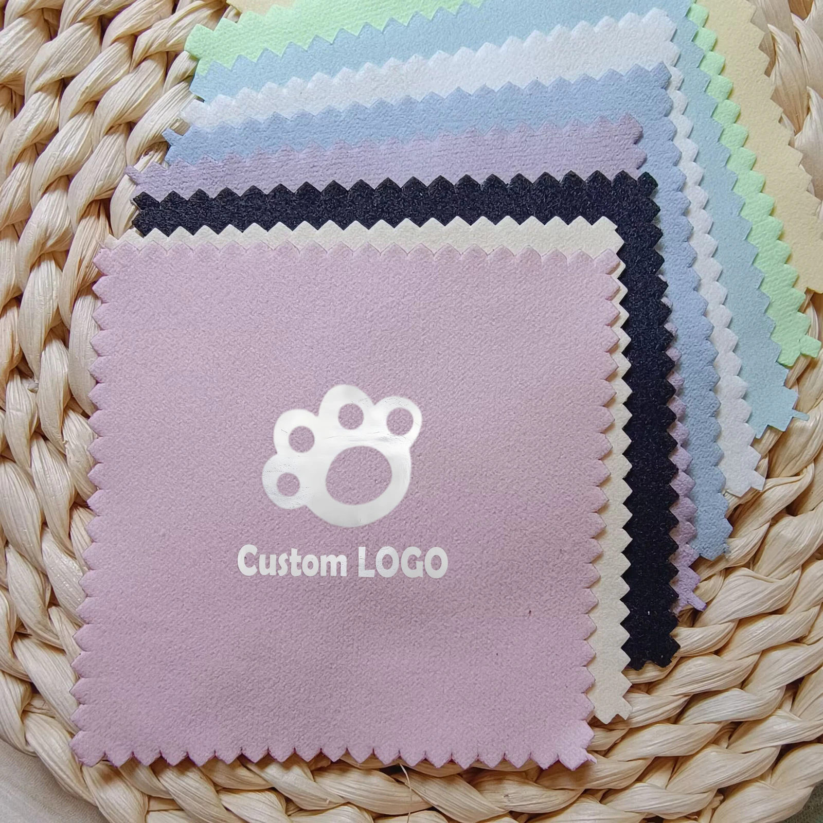 Assorted color jewelry polishing cloths with a metallic silver custom logo on the front lavender cloth